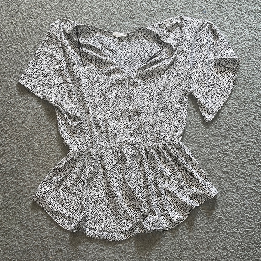 I am selling a tan and black spotted blouse